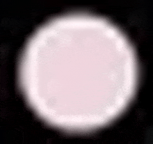 a white circle with a black background is floating in the air