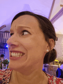 a close up of a woman 's face with a purple background