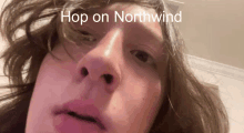 a close up of a person 's face with the words hop on northwind on the bottom