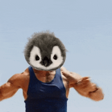 a man with a stuffed penguin head on his chest