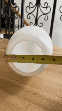 a stanley tape measure measures a white container