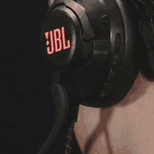 a person wearing a pair of jbl headphones on their head