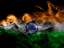 the flag of india is made of smoke and looks like it is being blown in the wind