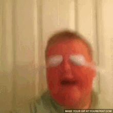 a blurry picture of a person 's face with a make your gif at yourrepeat.com link