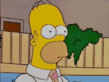 homer simpson from the simpsons is sitting in a pool with a fence in the background .