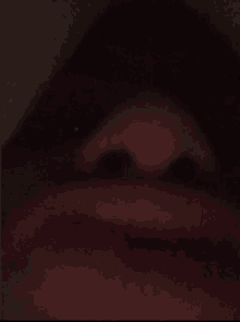 a close up of a person 's mouth and nose in the dark