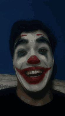 a man with a clown makeup on his face