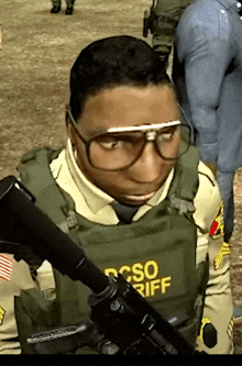 a man wearing glasses and a vest that says csi sheriff