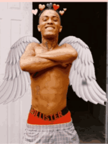 a shirtless man wearing hollister underwear with wings