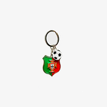 a keychain with a shield and soccer ball on it