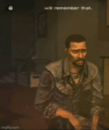 a man with a beard is sitting in a dark room in a video game