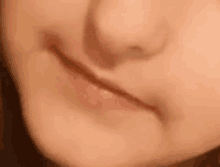 a close up of a child 's face with a smile on it .