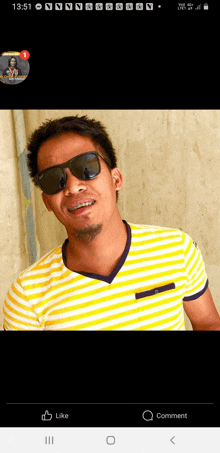 a man wearing sunglasses and a yellow and white striped shirt is standing in front of a wall