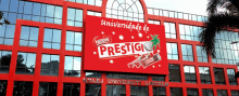 a red building with a nestle prestige sign on it