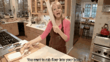 a woman in a kitchen with the words " you want to rub flour into your body " above her