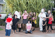 a group of children dressed up in halloween costumes pose for a picture