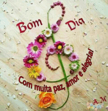 a treble clef made out of flowers with the words bom dia com muita paz amor e alegria