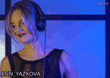 a woman is wearing headphones and the name ann yazkova is on the bottom right