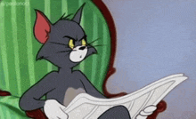 a cartoon cat is reading a newspaper while sitting in a chair .