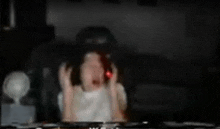 a blurry image of a person sitting in front of a television