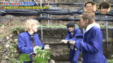 a group of young men are standing in front of a greenhouse with a sign that says a & i group