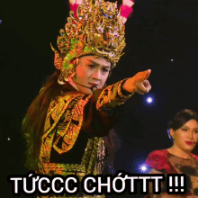 a man in a costume is pointing at the camera with a caption that says tuccc chotttt