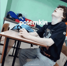 a person sitting at a desk with the word potemkin on the bottom right