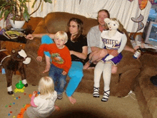 a group of people sitting on a couch with a cheerleader wearing a pirates jersey