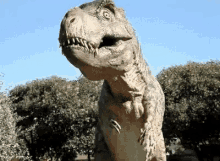 a statue of a t-rex dinosaur with its mouth open