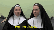 two nuns are standing next to each other with the words " you must have " written in yellow