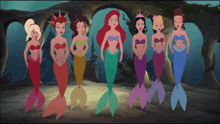 a group of mermaids are standing in a row