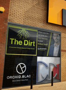 a sign on a building that says the dirt on it