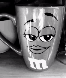 a m & m 's mug with a smiling face on it