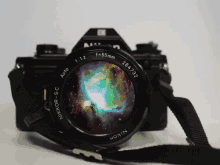 a nikkor camera shows a galaxy in its lens