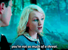 a girl in a blue sweater says " you 're not as much of a threat " next to a man