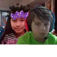 a boy and a girl with a purple bow on their faces