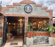 a brick building with a sign for sacho coffee milk tea shop