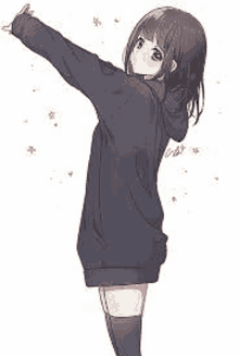 a girl in a hoodie is standing with her arms outstretched in the air .