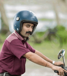 a man wearing a helmet that says ' nsr ' on it is riding a motorcycle