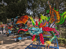 a display of colorful sculptures with a sign that says " atencion "