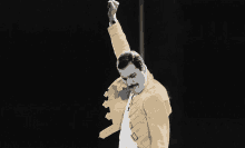 a man in a yellow jacket is holding his fist up in the air