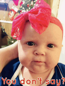 a baby wearing a pink headband with the words you don 't say