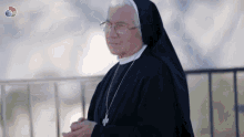 a nun with glasses and a cross on her chest