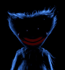 a blue stuffed animal with a red mouth and glowing eyes