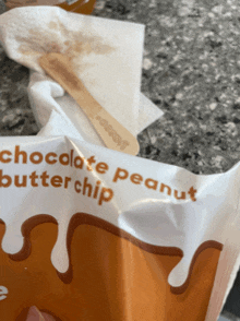 a bag of chocolate peanut butter chip next to a wooden spoon