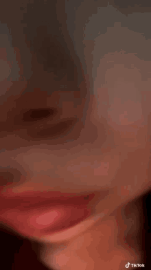 a close up of a person 's face with a blurry background