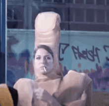 a woman smoking a cigarette while wearing a large finger costume