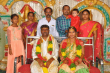 a group of people posing for a picture including a man in a plaid shirt