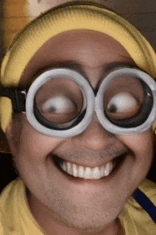 a man wearing a yellow hat and goggles makes a funny face