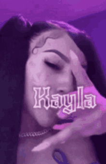 a woman with a purple background and the name kayla on her face